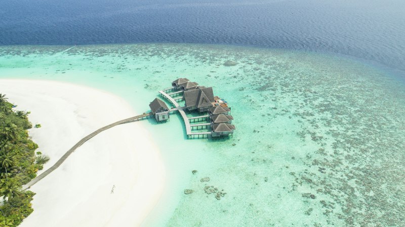 Maldives overwater villa deck sunset romantic honeymoon